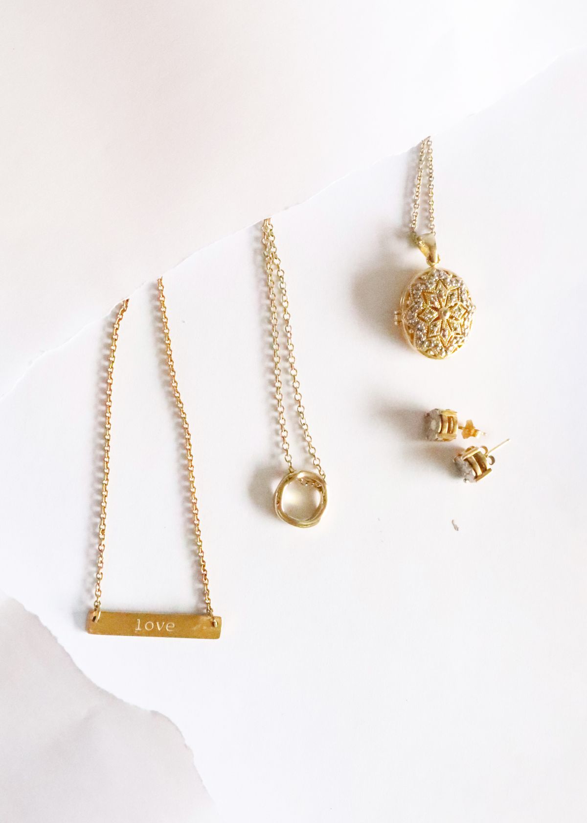 Elegant flat lay of gold jewelry pieces