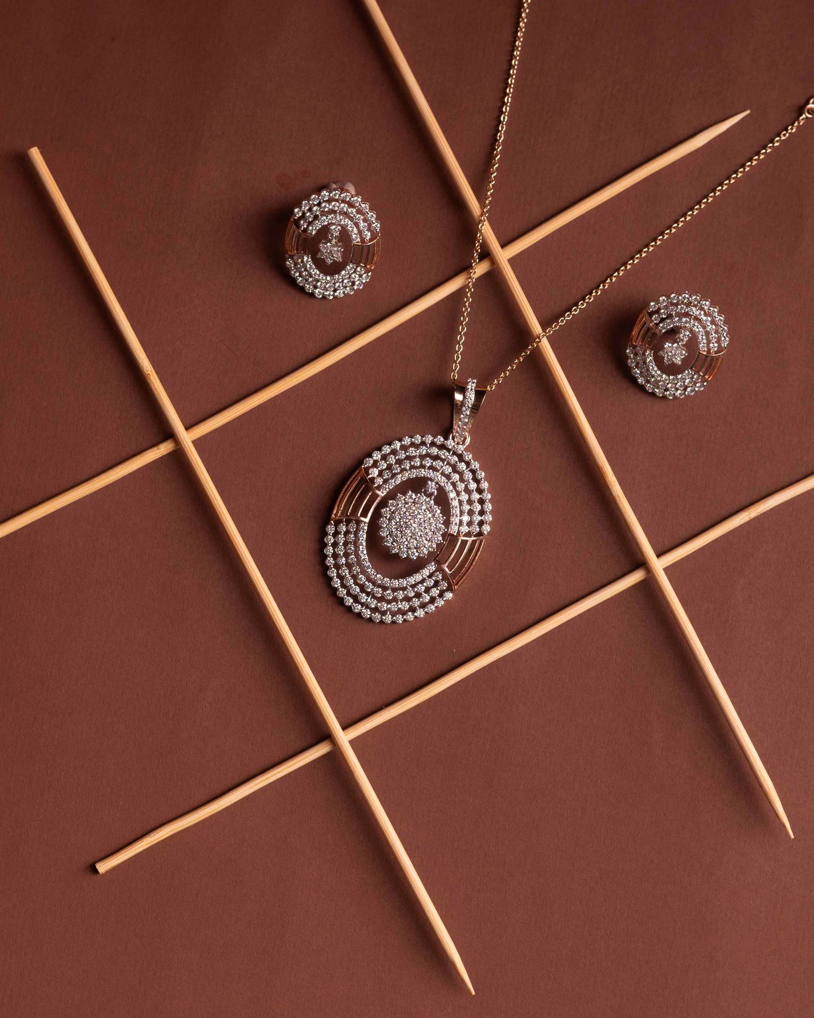 Elegant diamond jewelry set on brown background