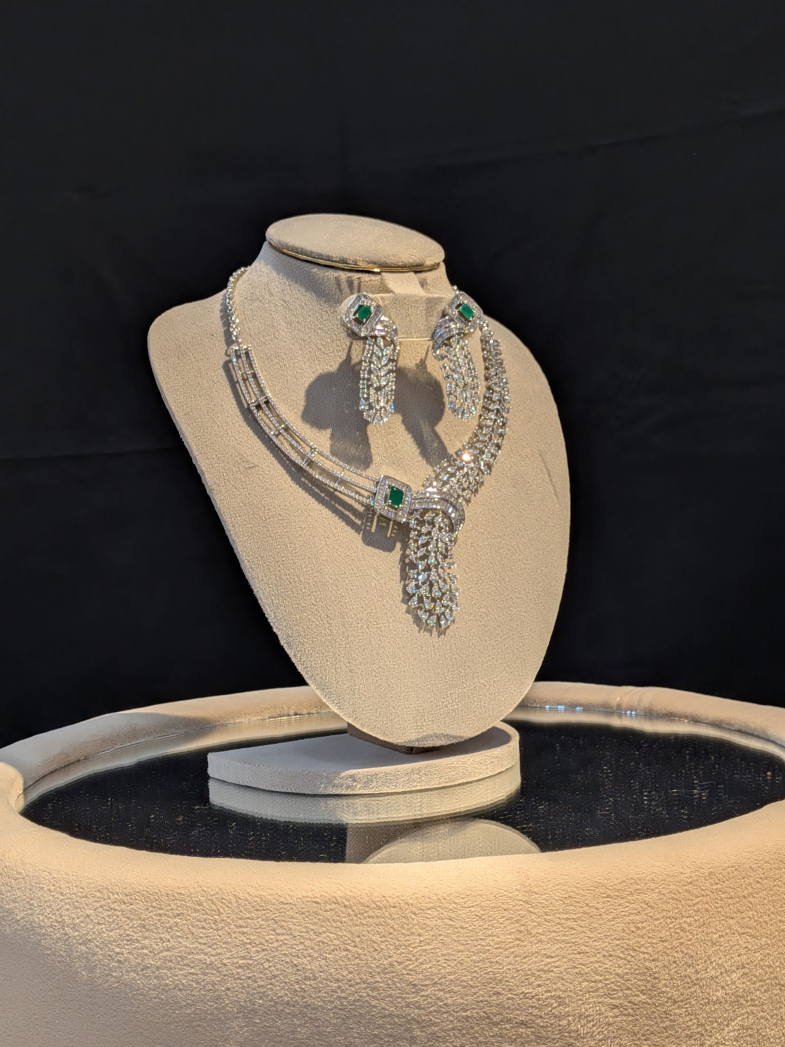 Elegant display of diamond and emerald jewelry