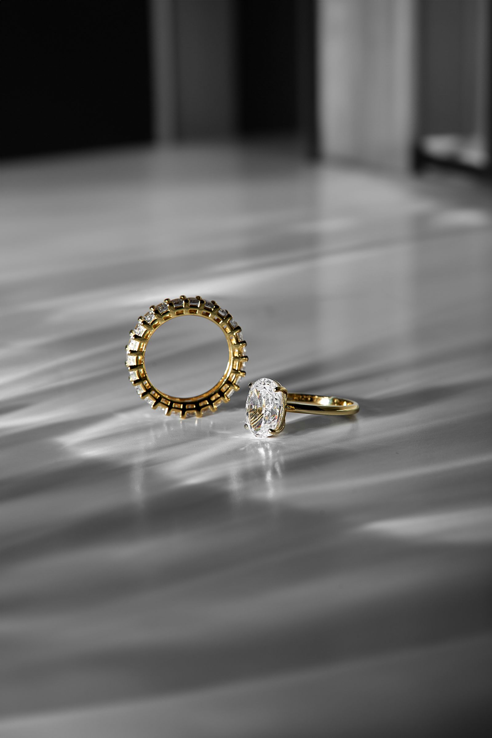 Gold and diamond rings on textured surface