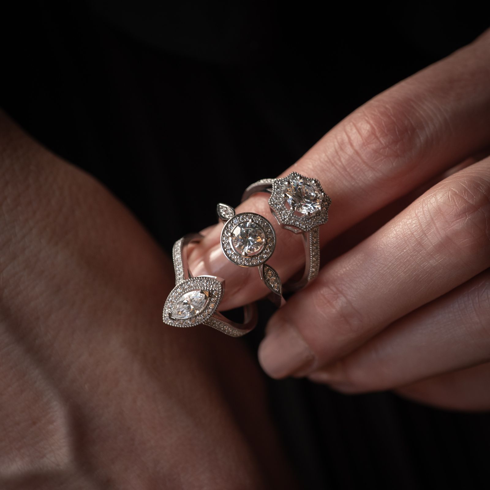 Diamond ring collection held in hand