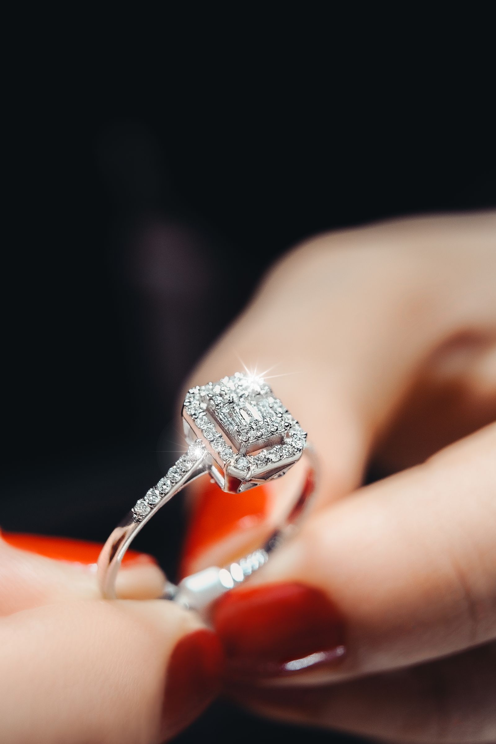 Close-up photo of person holding a diamond ring
