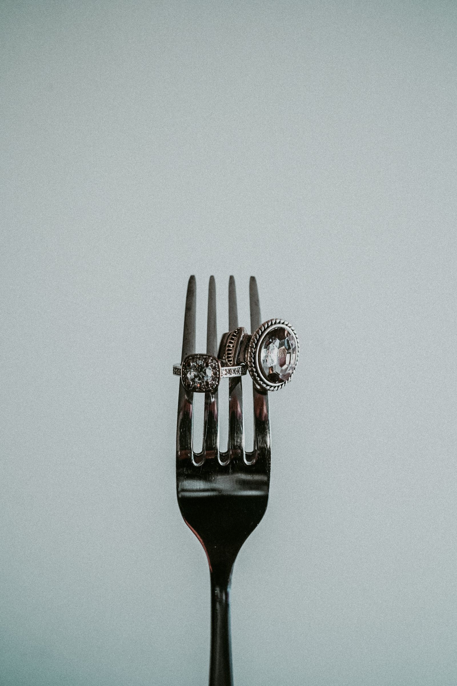 Elegant diamond rings displayed on silver fork