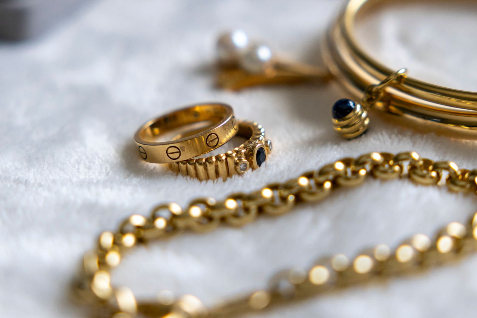 Assortment of gold chain jewelry on soft background