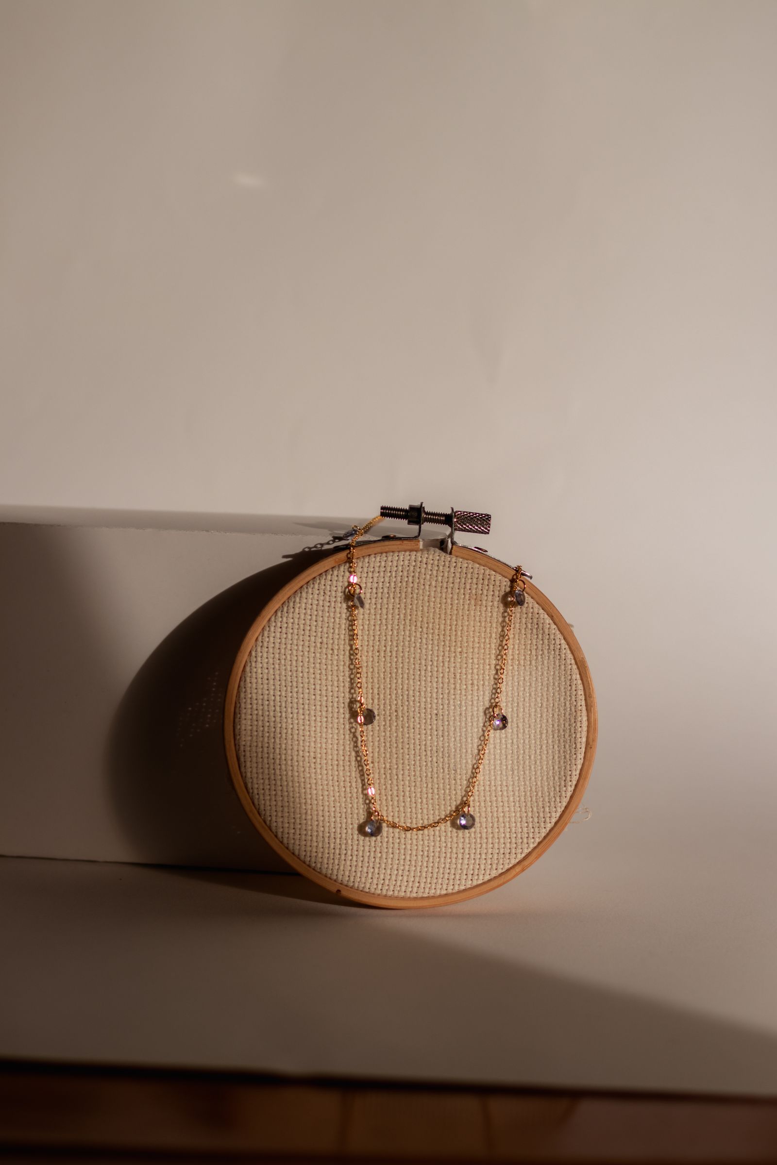 Gold necklace resting in sunlight